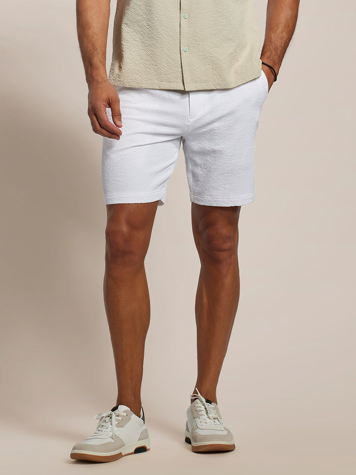 White textured shorts with cooling fabric solid Lanai shorts, front view, worn with beige shirt and sneakers.