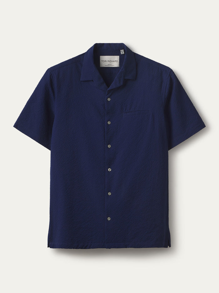 Navy solid short-sleeve cooling shirt with chest pocket, front flat lay view.