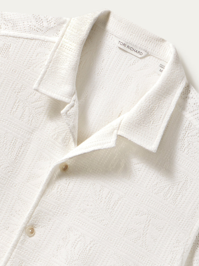 White textured short-sleeve collared shirt with buttons, front view.