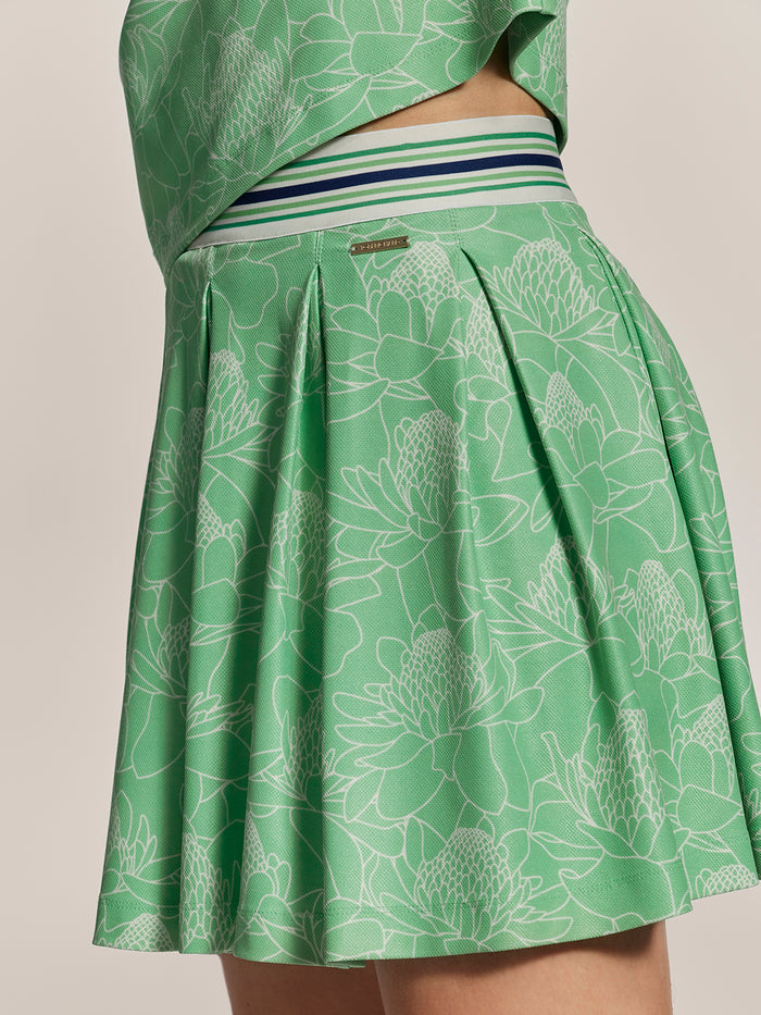 Green floral-print pleated skort with striped waist, waist-down view.