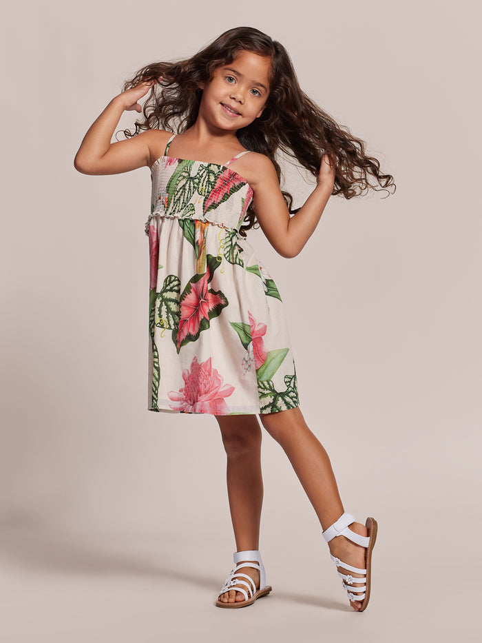 Cream with green-pink floral-print Adalei dress, sleeveless with gathered waist, girl posing in front view.