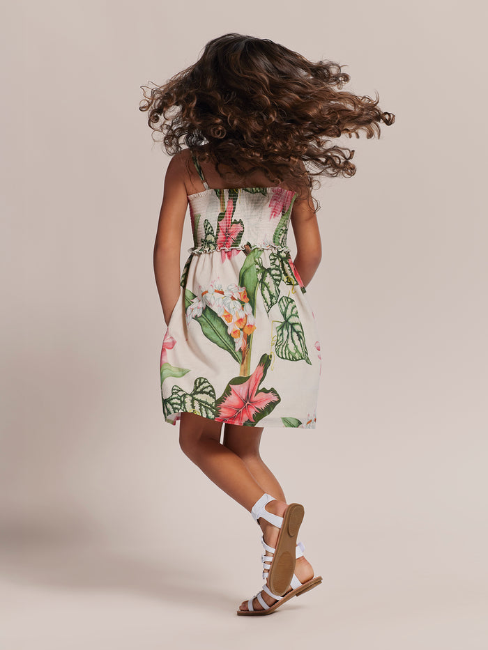 Cream with green-pink floral-print cotton voile girls' dress, twirling back view.