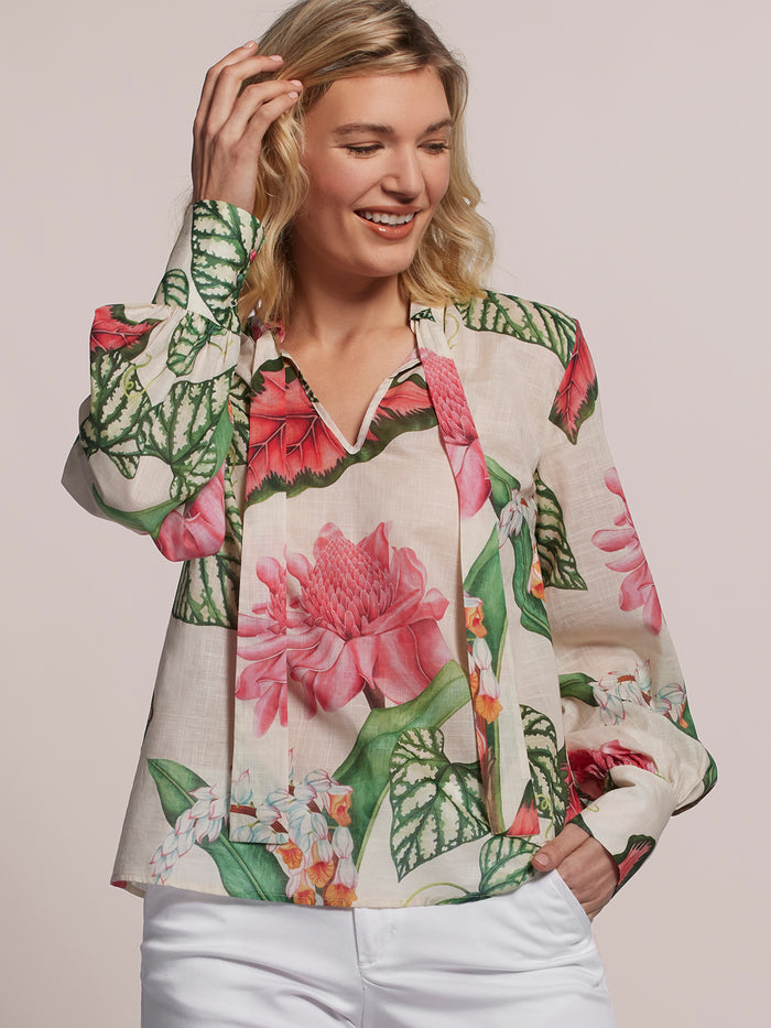 Multicolor floral-print cotton blouse, front view, with white pants.