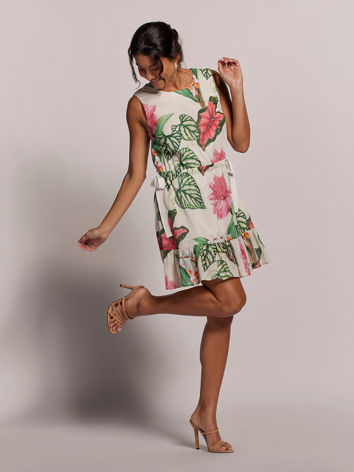 Blue floral mini dress with adjustable waist, shown in playful pose.