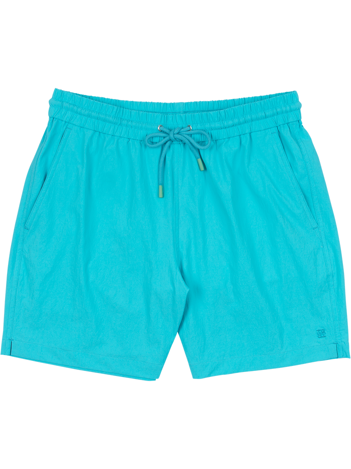 Bright turquoise swim shorts with elastic waist, drawstring, and pockets shown in flat lay view.