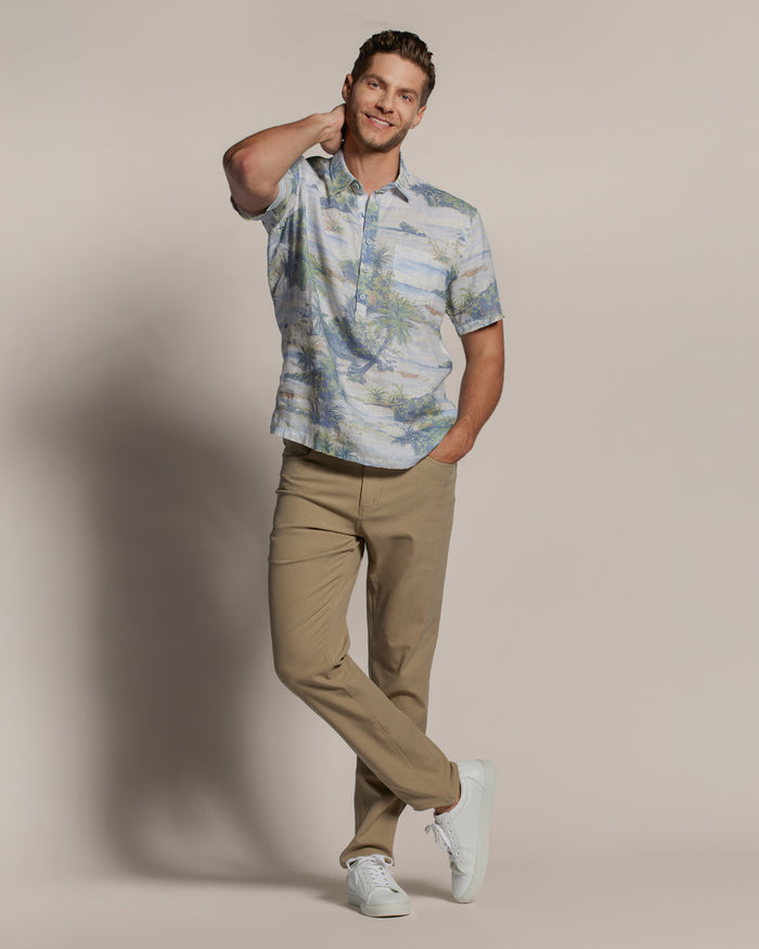 Blue patterned half-placket shirt, tan pants, and white sneakers, front view in both images.