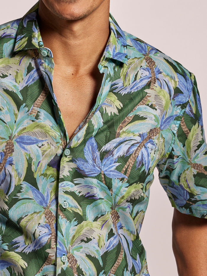 Green, blue, and tan palm tree print short-sleeve shirt in lightweight cotton lawn, front view.