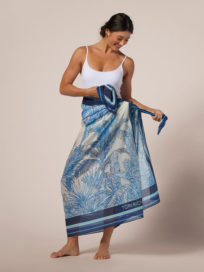 Blue and white tree-print pareo skirt, wrapped around waist, front view.