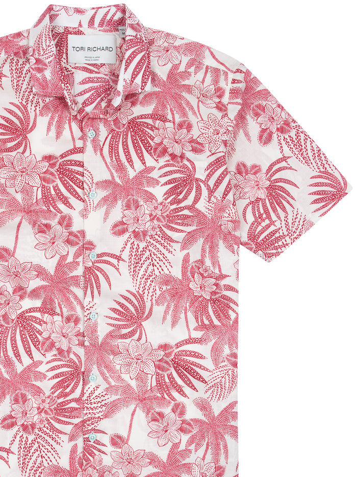 Red and white tropical-print cotton short-sleeve shirt, chest-up view.
