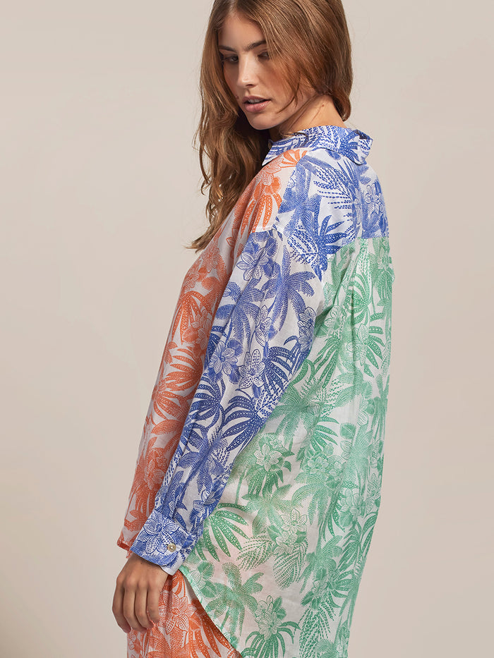 Multicolor color-blocked oversized long-sleeve shirt, side view of woman looking down left.