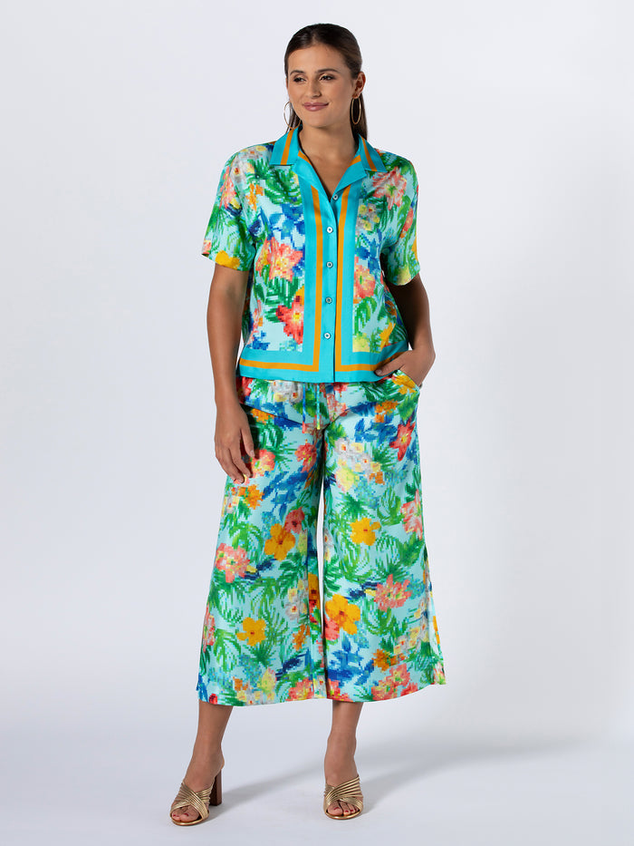 {{Tropical print multicolor cabana top, paired with white wide-leg pants, full front view}}.