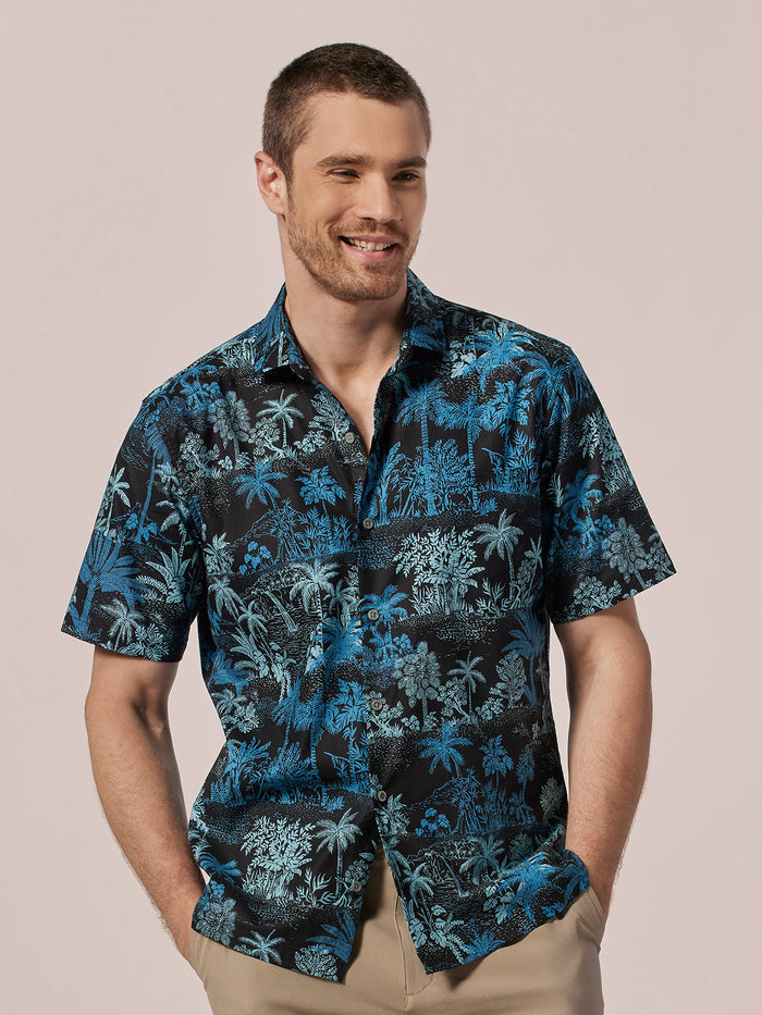 Multicolor tropical-print button-up shirt with chest pockets, front view against light background.