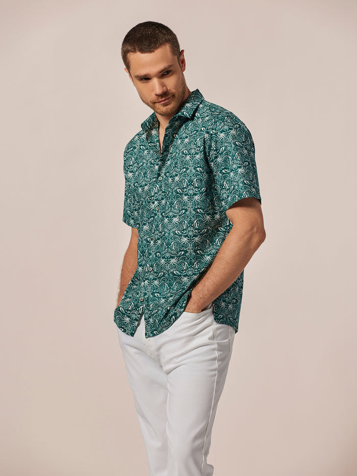 Green underwater-print cotton lawn shirt, front view, with white pants and hands in pockets.