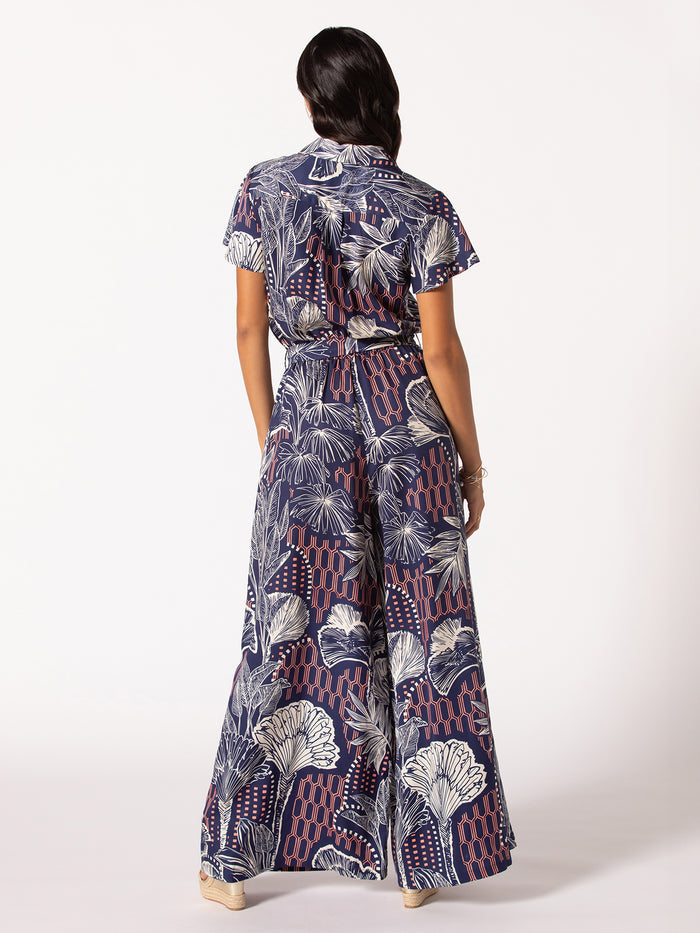 Navy blue solid wide-leg short-sleeve jumpsuit with belted waist, back view.