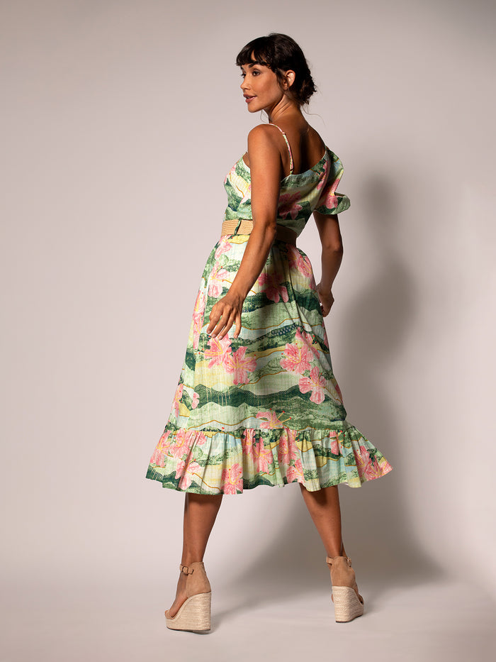 Green floral dress with ruffles, asymmetrical hem, full-length back view.