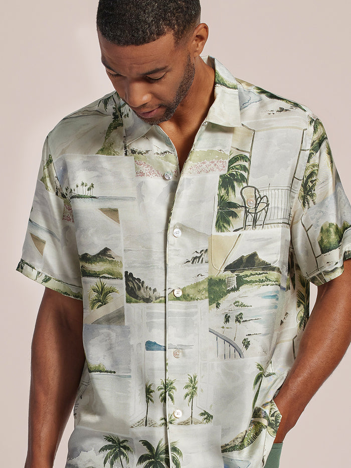 Cream sand-washed silk shirt, long sleeves, model looking down, front view