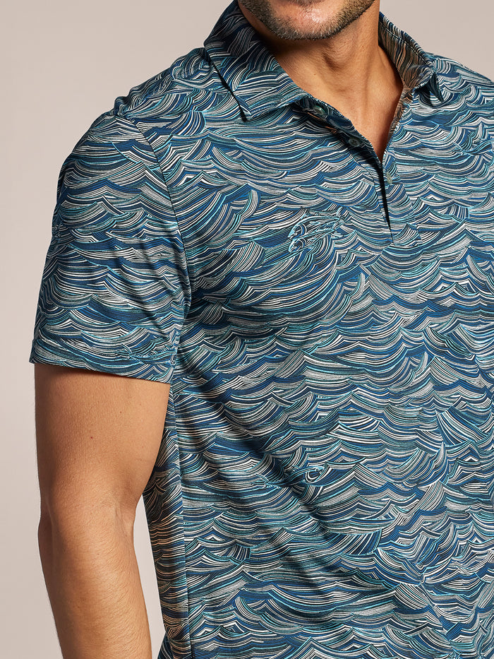 Blue ocean-pattern short-sleeve polo shirt, cropped mid-face to waist view.