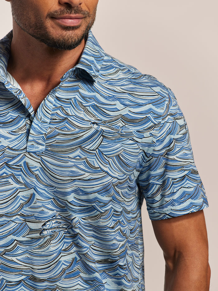 Blue abstract wave-print polo shirt, shoulders to mid-torso view.
