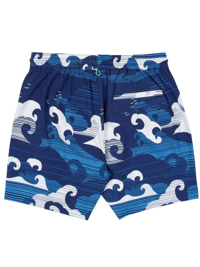 Blue swim trunks with white wave pattern and back pocket, shown in flat lay view.