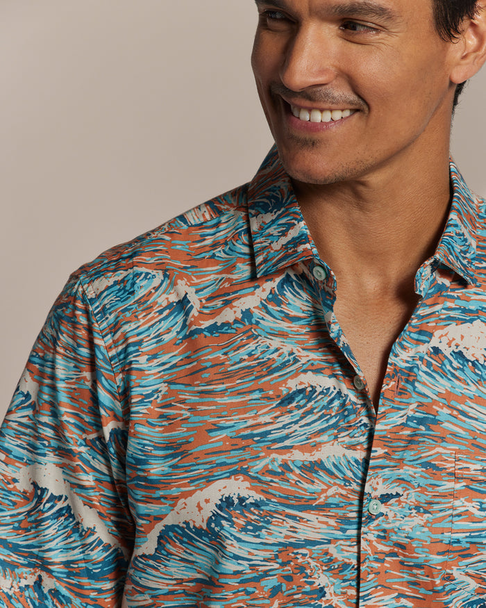 Orange, blue, and white abstract wave-print cotton short-sleeve shirt, front view of a model.