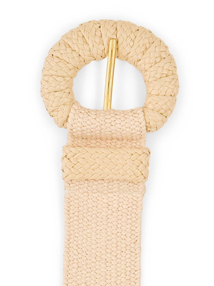 Tan woven raffia belt with braided round buckle and gold prong, close-up view.