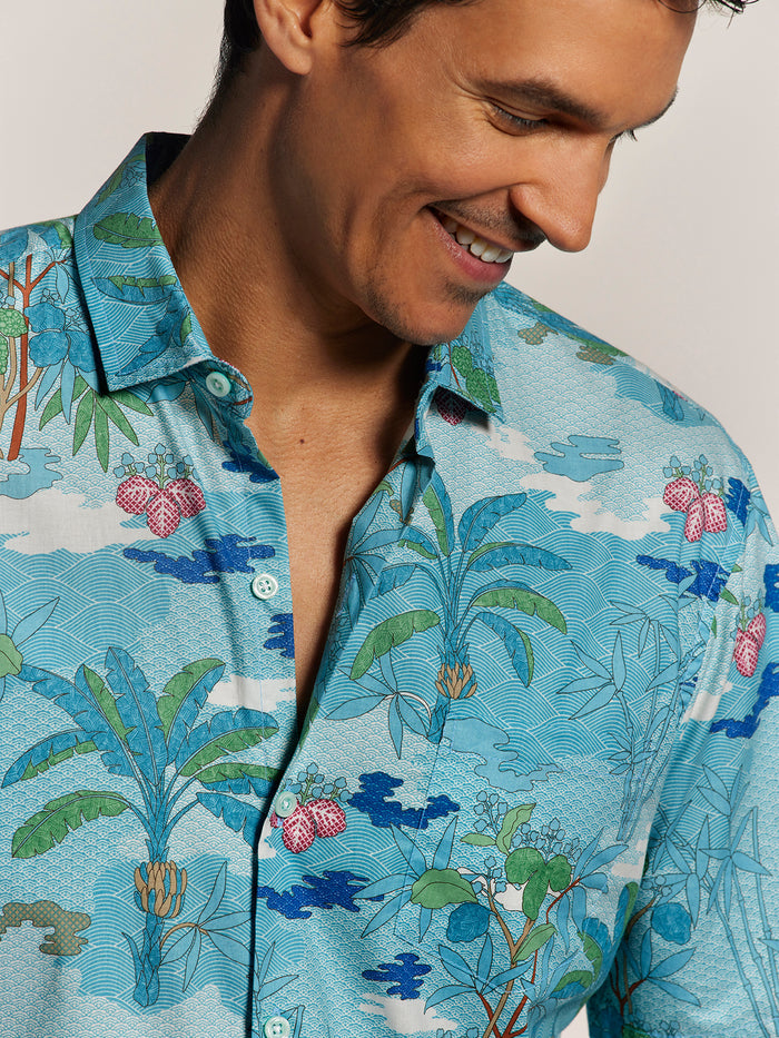 Blue banana tree and pink fruit print cotton short-sleeve shirt, front view.
